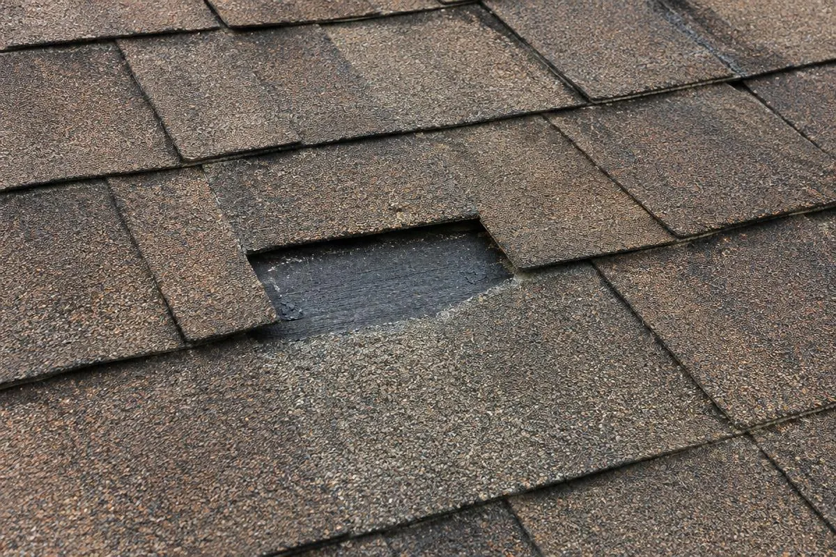 Missing shingle with nearby roof courses visible