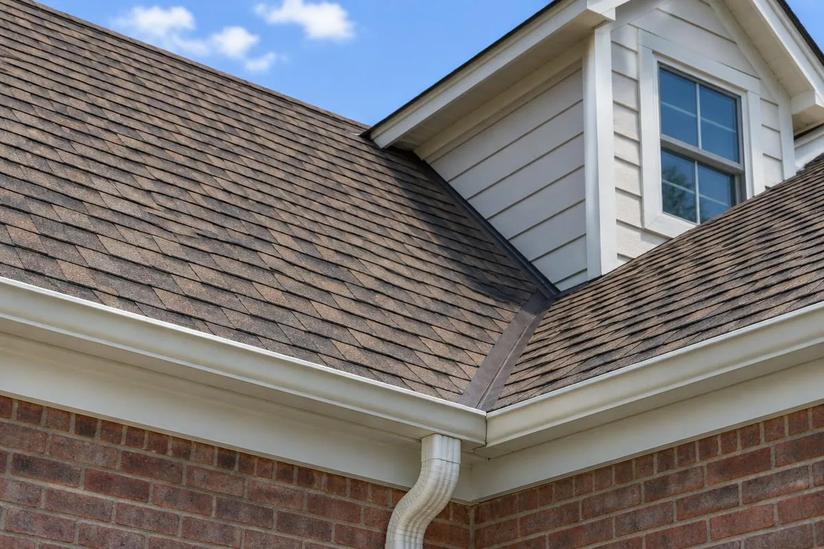 Two intersecting roof planes above a dormer with the valley outlet in view